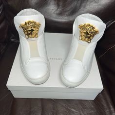 Womens High Top Versace Sneakers. All White With Large Gold Medusa Head. I Have The Original Box And Receipt As Pictured Very Good Condition Luxury White Calf Leather High-top Sneakers, Luxury High-top Sneakers In Calf Leather With Round Toe, Luxury High-top Sneakers With Leather Sole And Round Toe, Luxury White High-top Sneakers With Leather Sole, Luxury Calf Leather Slip-on Sneakers, Luxury High-top Sneakers With Leather Sole, Luxury Gold Custom Sneakers With Round Toe, Gold Dress Shoes Men, White And Gold Dress