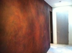 an empty room with a brown wall and door