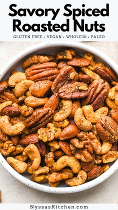 a white bowl filled with roasted nuts and text saying savory spiced roasted nuts