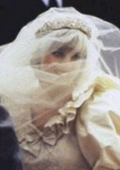 a woman wearing a veil and head piece