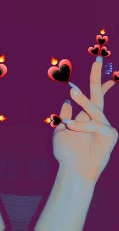 two hands with hearts on their fingers and one hand holding up the other's fingers