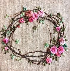 a close up of a piece of cloth with flowers on it and leaves in the middle