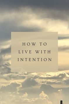 the words how to live with intention in front of a photo of clouds and buildings