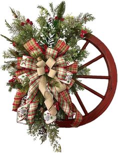 a christmas wreath on top of a wooden wheel