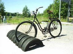 a bicycle is parked next to some tires