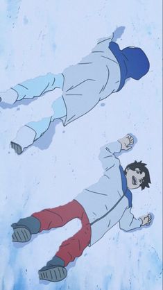 two people laying down in the snow with their feet up and one person standing behind them