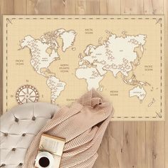 a world map is on the wall next to a chair and coffee cup with a book