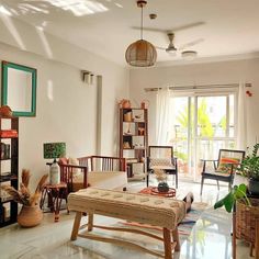 a living room filled with lots of furniture and decor on top of tiled flooring