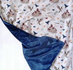 a blue and white blanket with harry potter symbols on it