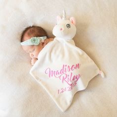 a baby wrapped in a blanket with a unicorn on it