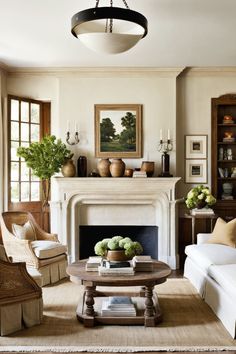 a living room filled with furniture and a fire place in front of a painting on the wall