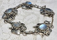 Similar in style to Scandinavian Skonvirke jewelry, this lovely hand-wrought bracelet was created with moonstones.  The five oval cabochons are bezel-set into five intricately constructed links of a nature theme.  The moonstones range from clear to exhibiting a white to pale blue adularescence.  There appears to be a variation, which is usually the case.  The central link is larger with the leaf design on both ends of the moonstone. The connecting links between the moonstone links are fabulous, Intricate Design Moonstone Jewelry, Elegant Adjustable Sterling Silver Moonstone Bracelet, Luxury Antique Moonstone Jewelry, Mystical Nickel-free Moonstone Jewelry, Artisan Moonstone Moon-shaped Jewelry, Blue Moonstone, Fashion 2024, Old Jewelry, Jewelry Lookbook