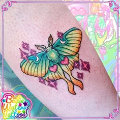 a colorful tattoo on the leg of a woman's legs with stars and a butterfly