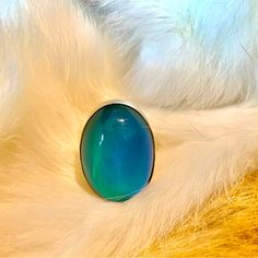 a close up view of a blue ring on white fur