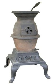 an old cast iron stove with a fan on it's top and bottom burner