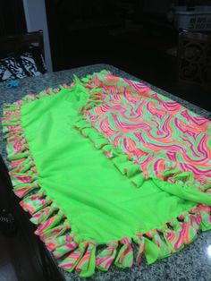 a green and pink blanket sitting on top of a counter