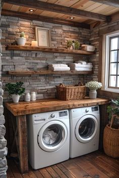 a washer and dryer in a room with stone walls, wood flooring and shelves