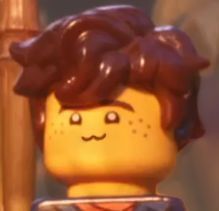 a close up of a lego man with red hair