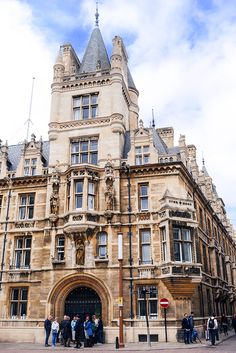 people are standing in front of an old building