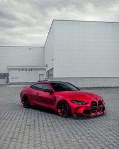 a red sports car parked in front of a building