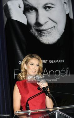 a woman standing at a podium in front of a poster