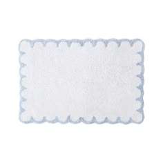 a white and blue rug with scalloped edges on a white background for use as a place mat