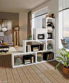 a living room filled with lots of furniture and bookshelves next to a window