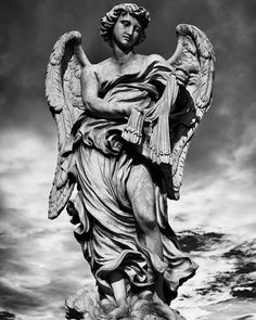 an angel statue is shown in black and white