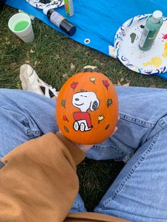 a person holding an orange ball with a cartoon character on it