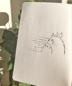 a notebook with a drawing of a cat on it