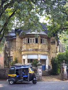 a tuk tuk parked in front of an old building