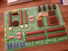 a cake made to look like an electronic circuit board with icing and chocolates on it