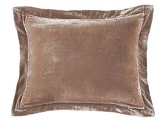 a brown velvet pillow on a white background