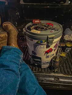 a person sitting in the back of a truck with their feet on an open grill