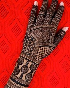 a woman's hand is decorated with hennap and intricate designs on it