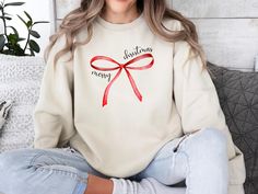 Embrace the sweet charm of the season with our Coquette Christmas Sweatshirt! Perfect for Christmas parties or a casual day out, this cozy sweatshirt features a delightful, feminine design with delicate holiday accents that capture the playful yet elegant Coquette style. Think soft pastels, lace-inspired details, and festive touches like mistletoe and bows. Whether you're sipping cocoa by the fire or heading to a holiday gathering, this sweatshirt adds just the right amount of festive flair to your look. Made with ultra-soft fabric for a comfortable fit, it's both stylish and cozy for all your seasonal adventures. Key Features: Chic Coquette-inspired Christmas design Ideal for parties or casual outings Soft, comfortable material Available in multiple sizes Step into a whimsical winter wond Elegant Coquette, Coquette Sweater, Christmas Coquette, Bow Coquette, Coquette Christmas, Coquette Style, Bow Sweater, Holiday Bows, Christmas Bow