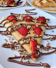 there are many desserts on this plate with chocolate and strawberries