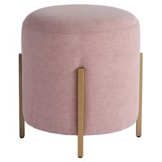 a pink ottoman with gold legs and a round foot rest on the bottom one end