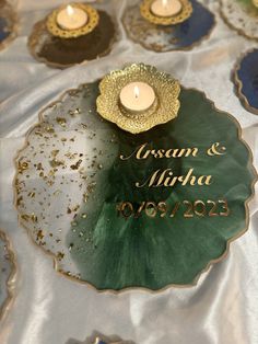 a couple of candles sitting on top of a table covered in plates and napkins