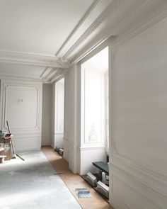 an empty room with white walls and wood flooring