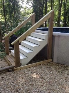 an outdoor hot tub with stairs leading up to it