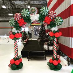 christmas decorations are on display at an indoor store in the holiday themed building, decorated with candy canes and candies