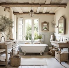 a white bath tub sitting inside of a bathroom next to two sinks and a window