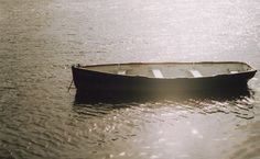 a small boat floating on top of a body of water