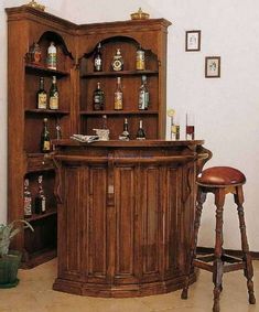 a wooden bar with stools in front of it