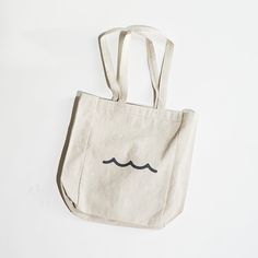 Carry your love for the shore wherever you go.This sturdy, gusseted tote is perfect for any errand or adventure — just the right size for your essentials without being too bulky.Details• 14"H x 10.5"W x 5"D• 12 oz cotton canvas• Side gussets• 23-inch handlesScreen printed in Rhode Island. Eco-friendly Everyday Tote Weekender Bag, Soap Company, Rhode Island, Cotton Canvas, Screen Printing, Reusable Tote Bags, The United States, Product Launch, Tote Bag