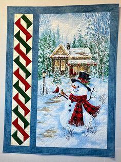 a snowman is standing in front of a house with a red and green scarf