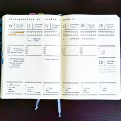 an open planner book sitting on top of a wooden table