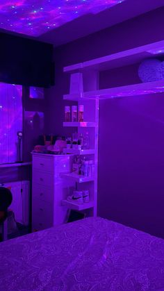 a bedroom with purple lights on the ceiling