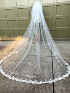 a bride's veil is on the ground in front of a garage door